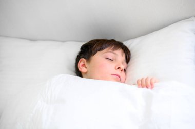 Close-up portrait of child sleeping in bed