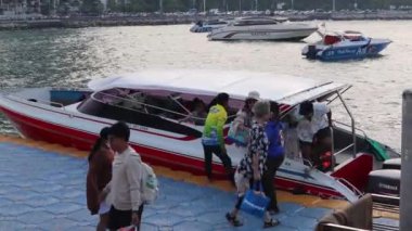 Vacationers after an island tour disembark from a speedboat in the Bali Hai Pier area of Pattaya in Thailand Asia