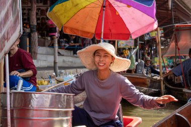 Various goods, such as Thai food or drinks, are offered for sale on an original floating market Samut Sakhon Thailand Asia clipart