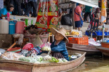 Various goods, such as Thai food or drinks, are offered for sale on an original floating market Samut Sakhon Thailand Asia clipart