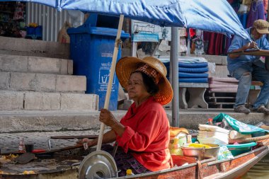 Various goods, such as Thai food or drinks, are offered for sale on an original floating market Samut Sakhon Thailand Asia clipart