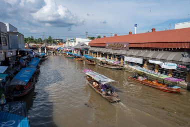 Various goods, such as Thai food or drinks, are offered for sale on an original floating market Samut Sakhon Thailand Asia clipart