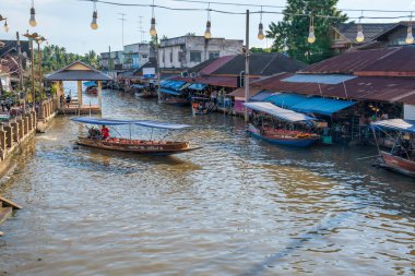 Various goods, such as Thai food or drinks, are offered for sale on an original floating market Samut Sakhon Thailand Asia clipart