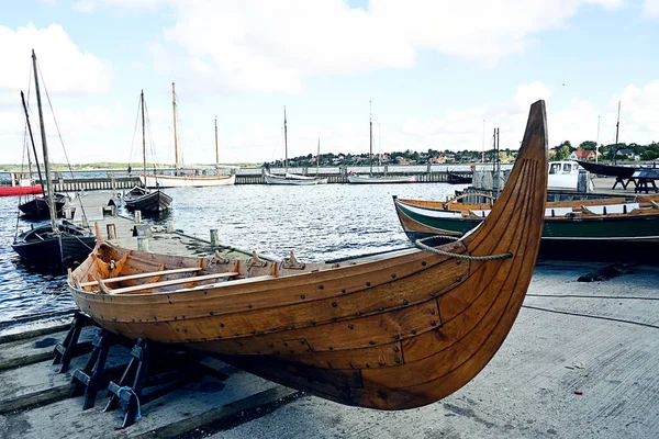Viking boat making, wooden boat on the shore, launching a ship.