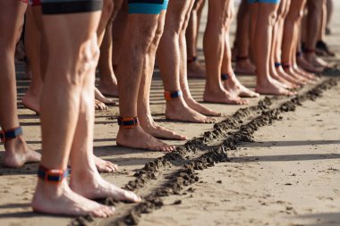 Triatlon sporcuları başlangıç çizgisinde hazır, yüzmede yarışıyorlar. Triatlonun yüzme ayağı