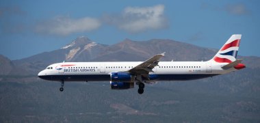 Tenerife, İspanya 30 Mart 2024. Airbus A321-231 British Airways Airlines mavi gökyüzünde uçuyor. Tenerife Havaalanına iniyor. Arka planda El Teide volkanı