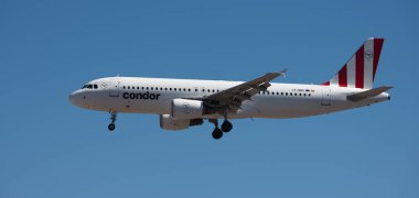 Tenerife, Spain may 4st, 2024. Airbus A320-214 Condor Airlines flies in the blue sky. Landing at Tenerife Airport clipart