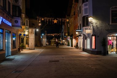KITZBUHEL, AUSTRIA - JANUARY 07, 2023: Night view of Kitzbuhel, a small Alpine town. Upscale shops and cafes line the streets of its medieval center.