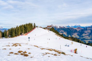 KITZBUHEL, AUSTRIA - JANUARY 08, 2023: Skiers enjoy winter sport on the slopes of Hahnenkamm mountain in Kitzbuhel, fashionable winter resort known for the annual Hahnenkamm downhill race