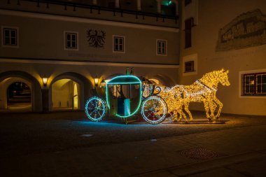 KITZBUHEL, AUSTRIA - JANUARY 07, 2023: Night view of Christmas street decoration in Kitzbuhel, a small Alpine town in Austria. Upscale shops and cafes line the streets of its medieval center. clipart
