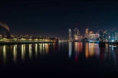 Night view of London and River Thames seen from Battersea neighbourhood, UK