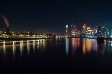 Night view of London and River Thames seen from Battersea neighbourhood, UK
