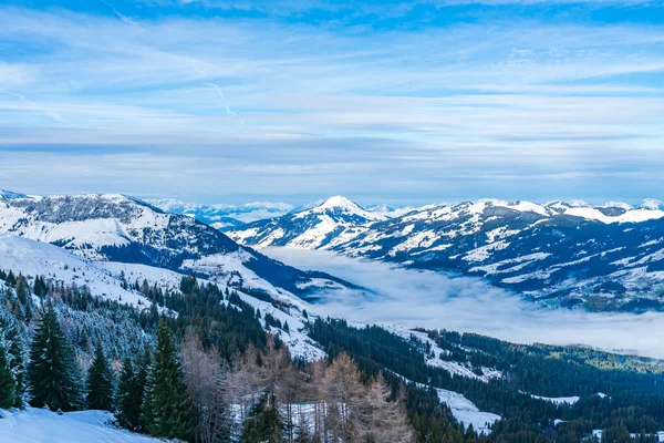 Aerial view of wintry landscape in Austrian Alps above low clouds covering Kitzbuhel in Austria
