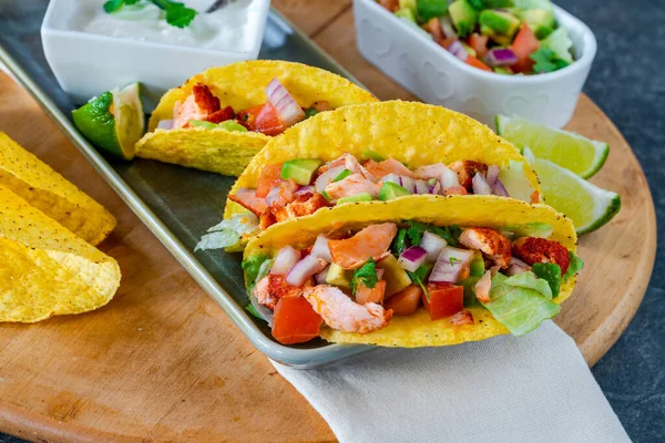 Grilled salmon tacos with avocado salsa