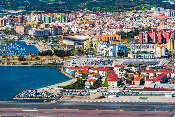 View of the Gibraltar airport runaway and Spanish town La Linea de Conception from the Upper Rock in Gibraltar, UK