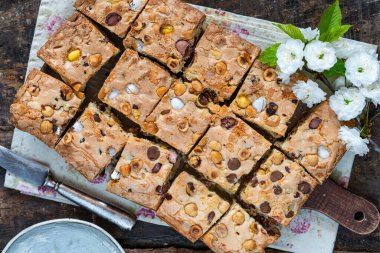Kare şeklinde kesilmiş fındıklı ve kızılcıklı Paskalya çikolatalı tepsi.