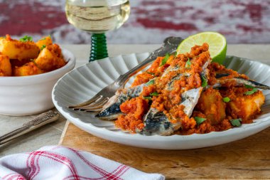 Baharatlı soslu kızarmış uskumru ve patates.