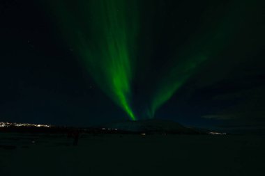 Aurora Borealis - Northern lights - above frozen lake Tornetrask in Abisko, Sweden clipart
