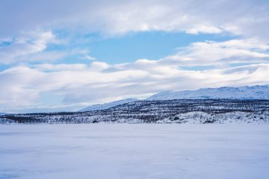 Frozen lake Tornetrask in Abisko, Sweden clipart