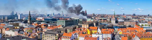 stock image Black smoke drifts over central Copenhagen as historic Copenhagen Stock Exchange goes up in flames. Denmark