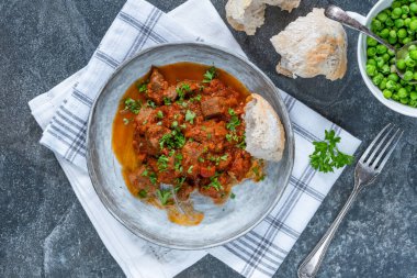 Kırmızı şarap ve domates soslu haşlanmış biftek güveci.