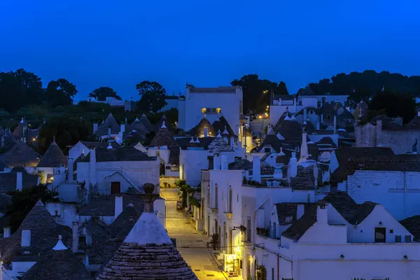 stock image ALBEROBELLO, ITALY - MAY 16, 2024: Night view of Alberobello, a small town in Puglia region famous for old dry stone trulli houses. 