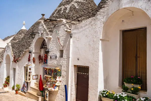 stock image ALBEROBELLO, ITALY - MAY 16, 2024: Alberobello is famous for its old dry stone trulli houses with conical roofs. Historical centre of Alberobello was declared by UNESCO as World heritage site.