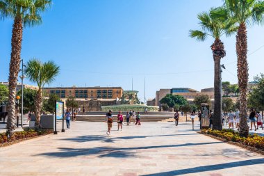 VALLETTA, MALTA - AUGUST 30 2024: The Tritons Fountain located in Floriana, consists of three bronze Tritons holding up a large basin. The fountain is one of Malta's most important Modernist landmarks clipart