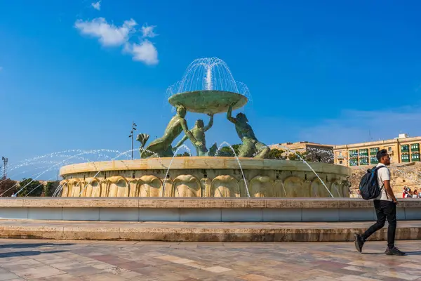 stock image VALLETTA, MALTA - AUGUST 30 2024: The Tritons Fountain located in Floriana, consists of three bronze Tritons holding up a large basin. The fountain is one of Malta's most important Modernist landmarks