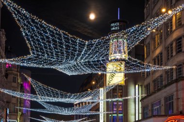 LONDON - NOVEMBER 15, 2024: Christmas lights on London's Coventry Street attract thousands of shoppers during the festive season and are a major tourist attraction in London clipart