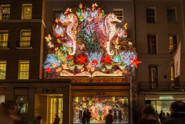 LONDON, UK - NOVEMBER 15, 2024: Dior shop in New Bond Street is decorated for Christmas. Dior is a French multinational luxury goods company. The House of Dior was established in 1946 in Paris. clipart