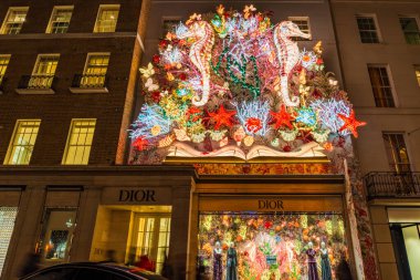 LONDON, UK - NOVEMBER 15, 2024: Dior shop in New Bond Street is decorated for Christmas. Dior is a French multinational luxury goods company. The House of Dior was established in 1946 in Paris. clipart