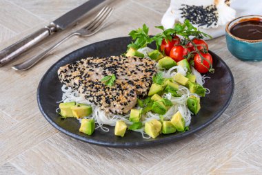 Sesame tuna steak with avocado salsa clipart