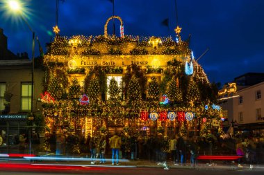 LONDON - DECEBMER 14, 2024: London's most iconic, historic pub Churchill Arms in Kensington is decorated for Christmas. Managed by Fuller's it is known for serving real ales and authentic Thai cuisin. clipart