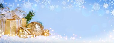 Christmas golden decoration and gift isolated on blue blur background. clipart