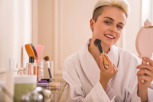 Positive Careful Woman White Bathrobe Putting Powder Brush Her Face — Stock Photo, Image