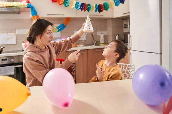 Caucasian Woman Putting Party Hat Her Son Genetic Disorder While — Stock Photo, Image