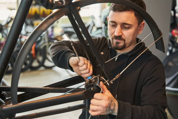 Allvarlig Kaukasisk Manlig Arbetare Reparera Cykel Hjul När Står Verkstad — Stockfoto