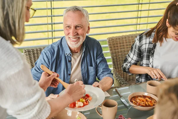 Seniorin Serviert Der Familie Hause Essen Reifer Mann Der Sie — Stockfoto