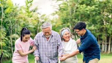 Portre, mutlu, gülümseyen, çok nesildir gülümseyen Asyalı büyük kucaklama ailesinin keyfini çıkarın. Yaşlı bir baba ve yaşlı bir anne ve genç bir kadın ve oğlu ile birlikte evde park halinde. Sigorta kavramı.