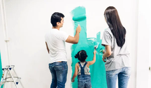 Szczęśliwa Azjatycka Rodzina Używa Wałka Malowania Ścian Swoim Nowym Domu — Zdjęcie stockowe