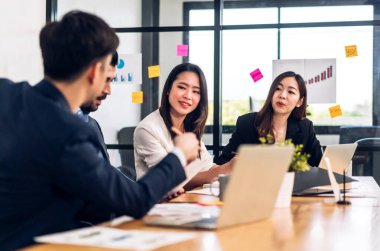 Asya iş toplantıları ve strateji projesi analizi finans süreci tartışmaları. İş adamları planlarını ve pazarlama fikirlerini ofiste dizüstü bilgisayarla işlerler. Takım çalışması