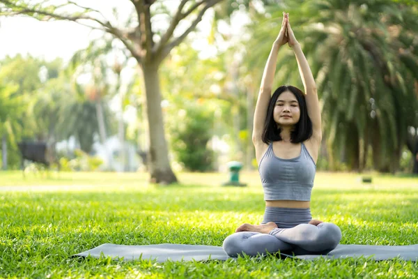 Portrait sport asian beauty body slim woman in sportswear sitting relax and girl practicing yoga and do fitness exercise in park at home.Diet concept.Fitness and healthy