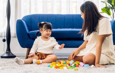 Mutlu bir aşk portresi. Asyalı bir anne ve küçük Asyalı bir kız gülümsüyor. Yetenekli bir beyin eğitimi.