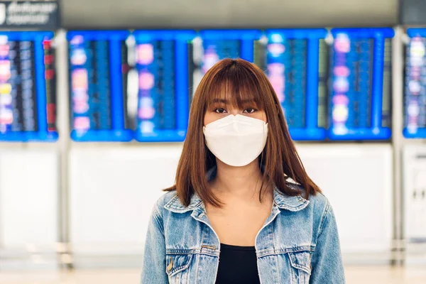 stock image Young beautiful asian woman in quarantine for coronavirus wearing surgical mask face protection with social distancing at city.covid19 concept