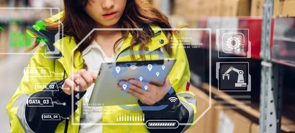 Asian engineer woman shipping order detail on tablet smart network check goods and supplies with goods Infographic inventory in factory warehouse.logistic technology industry and business distribution