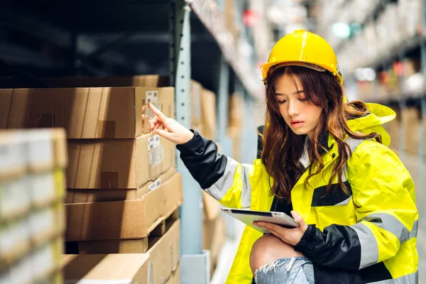 stock image Portrait asian engineer woman shipping order detail on tablet check goods and supplies on shelves with goods background inventory in factory warehouse.logistic industry and business export