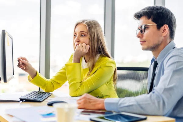 stock image Two professional business man and woman meeting analyzing data and discussing strategy with new startup project.Creative business people planning and brainstorm with desktop computer in modern office.Teamwork