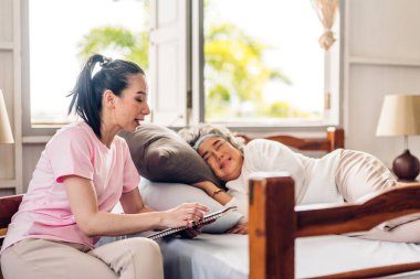 Mutlu bir aşk portresi. Asyalı bir aile. Yaşlı, olgun bir anne ve genç bir kız. Gülümseyen, kucaklayan ve birlikte eğlenen.