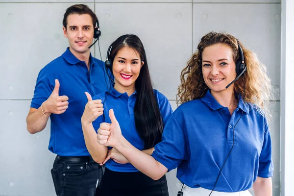 Group of happy call center smiling business operator customer help support team phone services agen working and look at camara with headset  at call center office